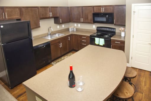 Large kitchen with extra storage and dark cabinets at The Sterling Kearney  in Kearney, NE