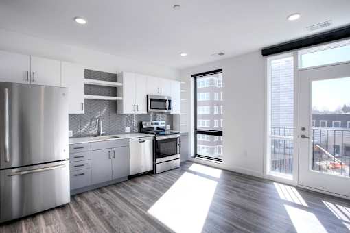 A modern kitchen with stainless steel appliances and a view of the city.
