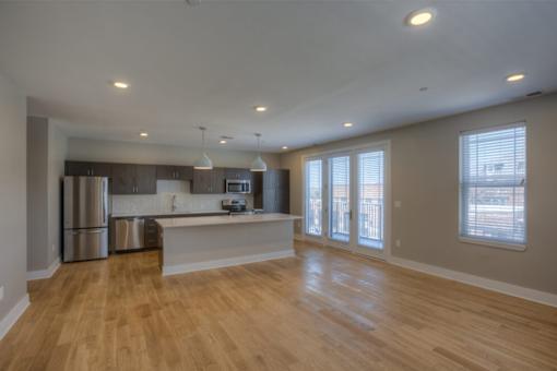 A kitchen with wooden floors and stainless steel appliances.