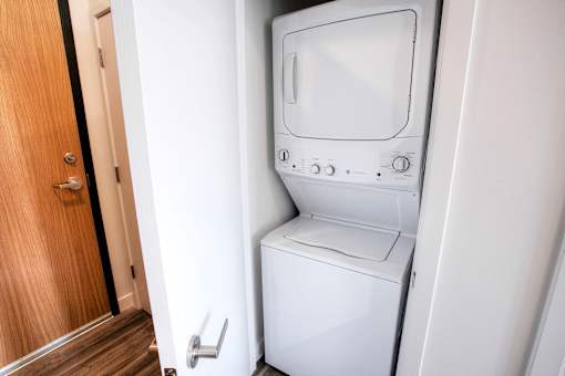 A white washing machine and dryer in a small laundry room.