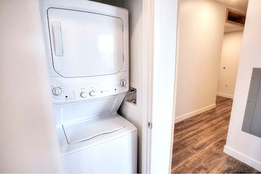 A white microwave oven is on the left and a white washing machine is on the right.