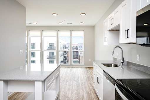 A modern kitchen with a view of the city.