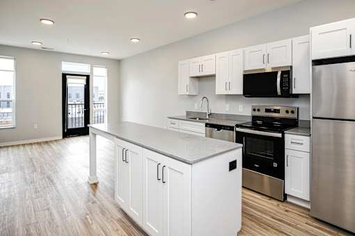 A kitchen with white cabinets and stainless steel appliances.