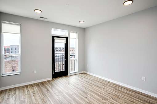 A room with a black door and a window.