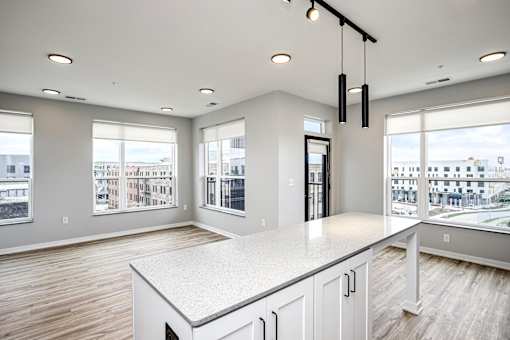 A spacious kitchen with a large island and a view of the city.