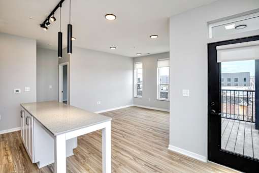 A modern kitchen with a large island and a view of the city.