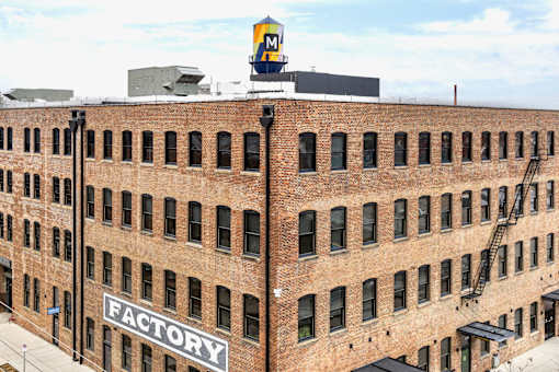 A brick building with a sign that says "Factory" on it.