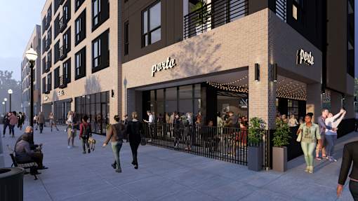A street view of a PETA store with people walking by.