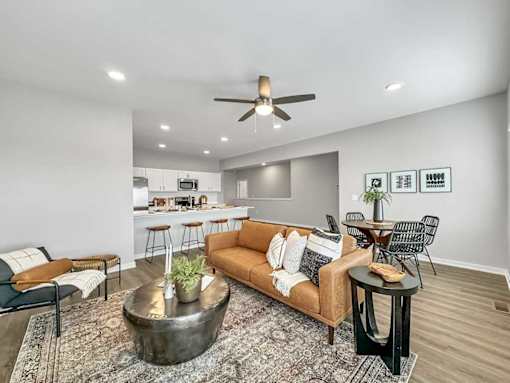 A living room with a brown couch and a coffee table.