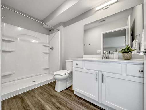A white bathroom with a toilet, sink, and bathtub.