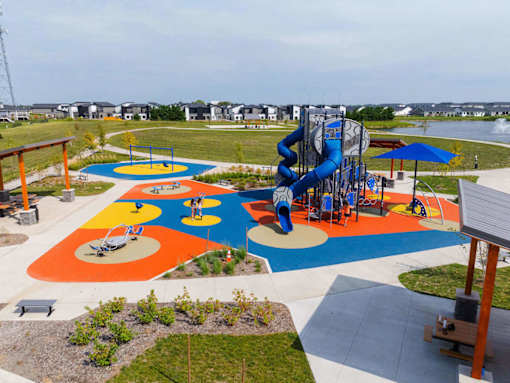 A playground with a blue slide and a yellow and blue play area.