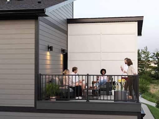 A group of people are sitting on a balcony.