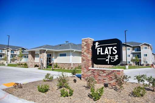 A sign for Flats 45 is in front of a building.