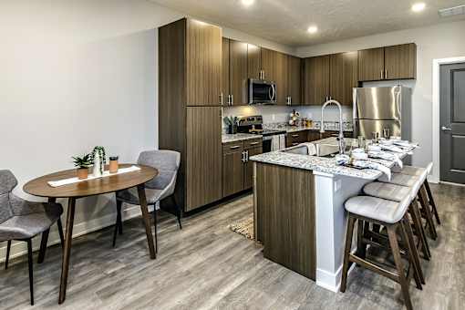A modern kitchen with a table and chairs.