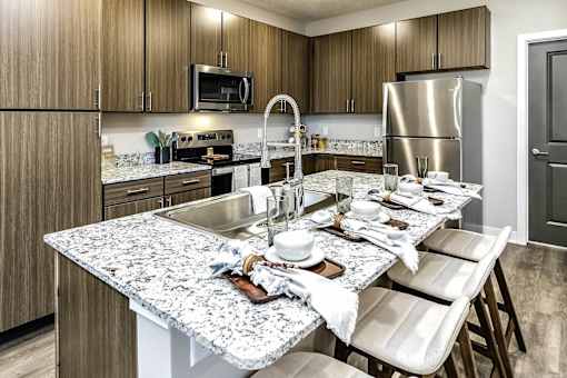A kitchen with a granite countertop and a sink.