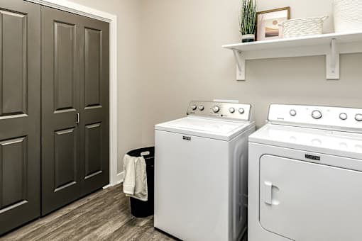A white washing machine and dryer in a laundry room.