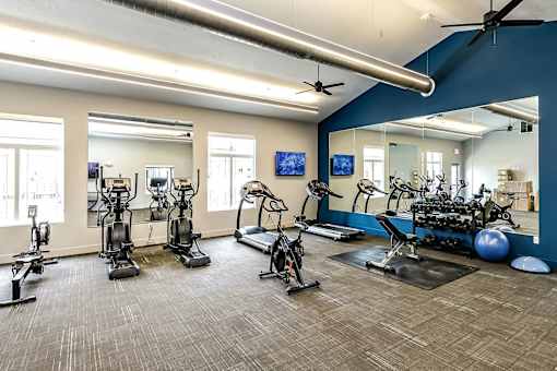 A spacious gym with a variety of exercise equipment.
