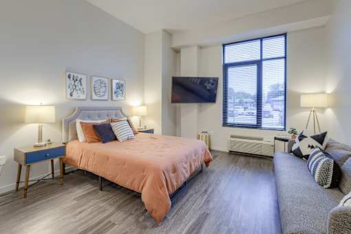 A bedroom with a large bed and a couch.
