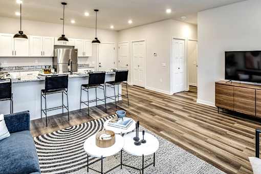 A modern kitchen with a dining table and chairs.
