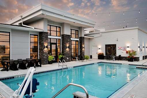 A modern house with a pool in the backyard.