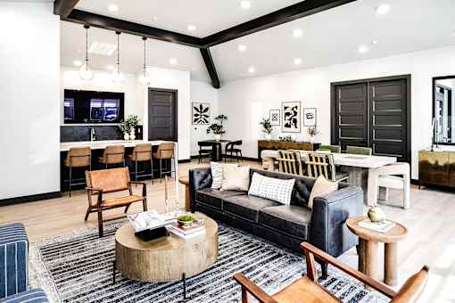 a living room with a couch and a table and a kitchen