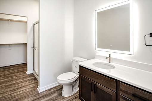 One, two and three-bedroom floor plans featuring two interior design schemes, quartz countertops, tile backsplash, stainless steel appliances, backlit mirrors, high-end finishes and more at 148 Place Apartments in Omaha, NE