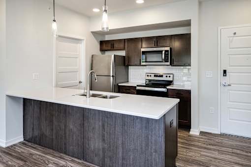 One, two and three-bedroom floor plans featuring two interior design schemes, quartz countertops, tile backsplash, stainless steel appliances, backlit mirrors, high-end finishes and more at 148 Place Apartments in Omaha, NE