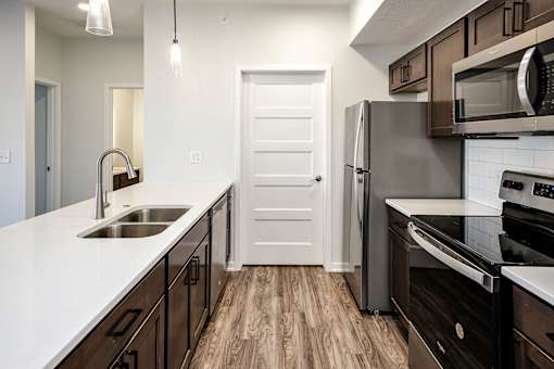 One, two and three-bedroom floor plans featuring two interior design schemes, quartz countertops, tile backsplash, stainless steel appliances, backlit mirrors, high-end finishes and more at 148 Place Apartments in Omaha, NE