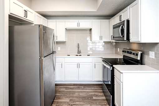 One, two and three-bedroom floor plans featuring two interior design schemes, quartz countertops, tile backsplash, stainless steel appliances, backlit mirrors, high-end finishes and more at 148 Place Apartments in Omaha, NE