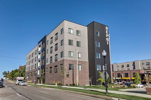 A modern apartment building with the name "Bedrock" on the side.