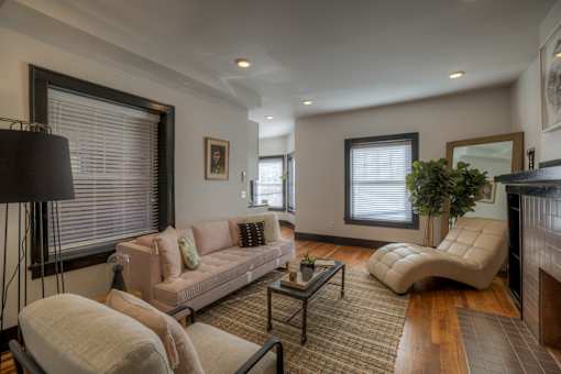 A living room with a couch, chair, and coffee table.