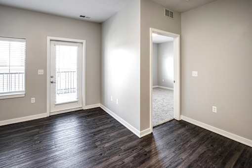 Living Room with balcony at Deerfield Apartments and Chateaus in Fremont, NE