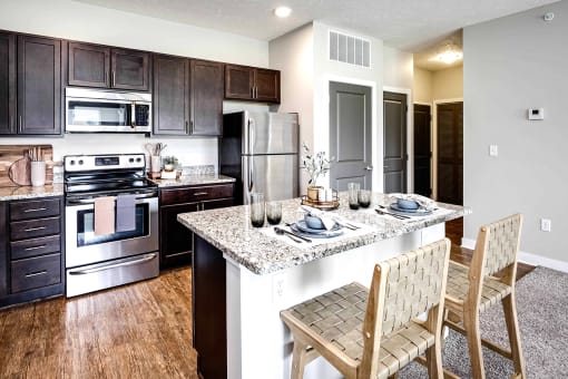 Luxury studio, one, and two bedroom apartment homes featuring granite countertops, stainless steel appliances, and fireplaces at East Lake Flats in Lincoln, NE
