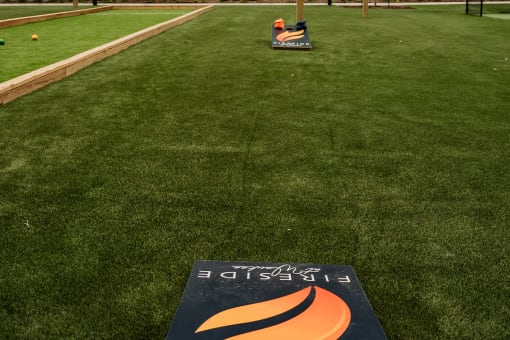a baseball field with a sign in the middle of the grass