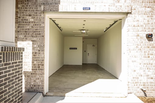 the entrance to a building with a long hallway with a white door