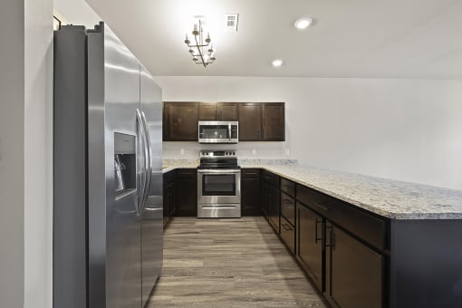 Three-bedroom townhomes featuring stainless steel appliances, premium LVT flooring, two car garage and much more at Hawthorne Row Townhomes in Bentonville, AR