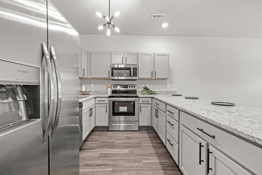 Three-bedroom townhomes featuring stainless steel appliances, premium LVT flooring, two car garage and much more at Hawthorne Row Townhomes in Bentonville, AR