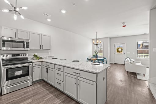 Three-bedroom townhomes featuring stainless steel appliances, premium LVT flooring, two car garage and much more at Hawthorne Row Townhomes in Bentonville, AR