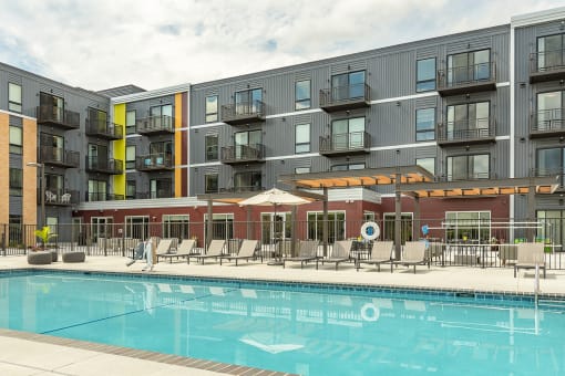 The Sanctuary Deck featuring a resort-style pool, firepit, summer kitchen with outdoor grills, hammocks and bocce ball court at The Nexus at Gray's Landing in Downtown Des Moines, IA