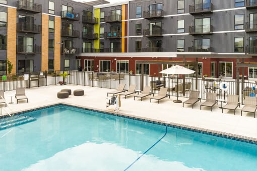 The Sanctuary Deck featuring a resort-style pool, firepit, summer kitchen with outdoor grills, hammocks and bocce ball court at The Nexus at Gray's Landing in Downtown Des Moines, IA