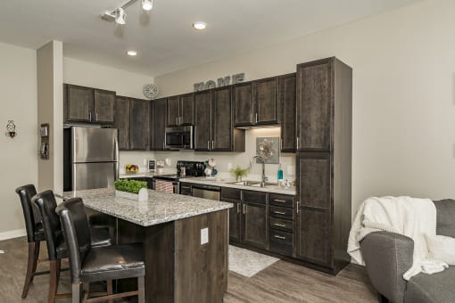 One and two bedroom hi-end apartment homes featuring Energy-Efficient Stainless Steel Appliances,  Granite Kitchen Island, dark cabinets, and much more at The Nexus at Gray's Landing in Downtown Des Moines, IA