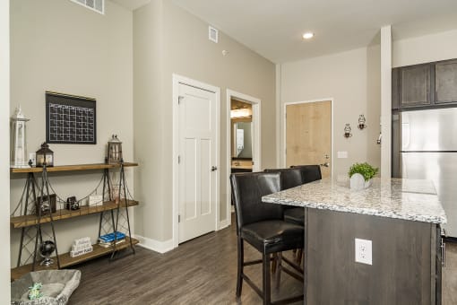 One and two bedroom hi-end apartment homes featuring Energy-Efficient Stainless Steel Appliances,  Granite Kitchen Island, dark cabinets, and much more at The Nexus at Gray's Landing in Downtown Des Moines, IA