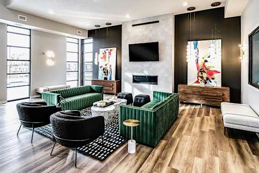 A modern living room with a green sofa and a fireplace.