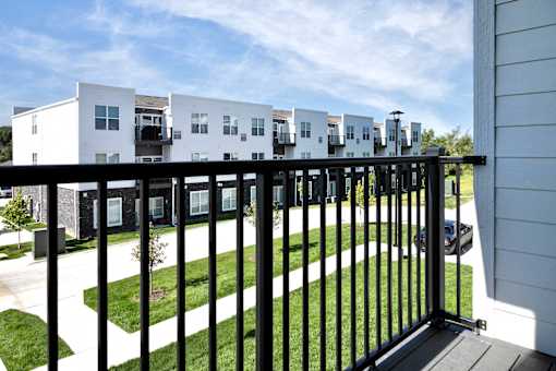 A white building with a black fence in front of it.