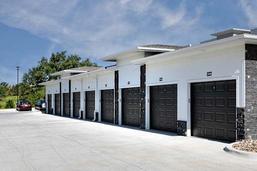 A row of black garage doors are closed.
