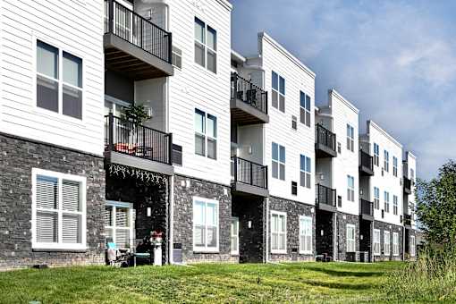 Apartment building with balconies and windows.