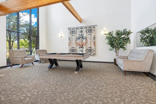 Modern clubhouse featuring community lounge, coffee bar, salon and spa, billiards and poker room, and concierge package room at Parkside Apartments and Shops in Bentonville, AR