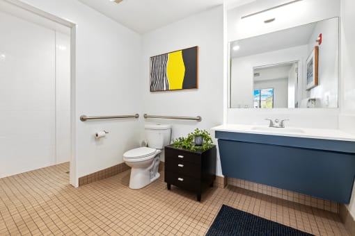 Upscale studio, one, and two-bedroom apartment homes featuring two-tone kitchen cabinetry, quartz countertops, stainless steel appliances, luxury vinyl wood flooring, and much more at Parkside Apartments and Shops in Bentonville, AR