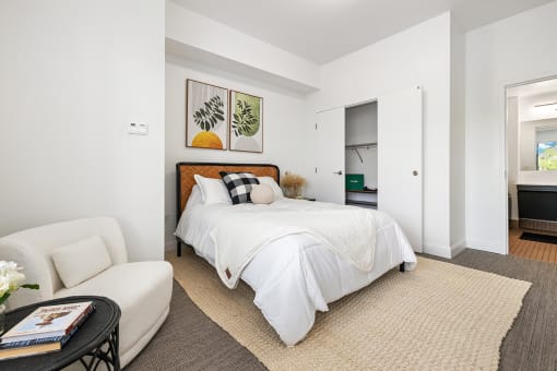 Upscale studio, one, and two-bedroom apartment homes featuring two-tone kitchen cabinetry, quartz countertops, stainless steel appliances, luxury vinyl wood flooring, and much more at Parkside Apartments and Shops in Bentonville, AR