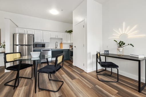 Upscale studio, one, and two-bedroom apartment homes featuring two-tone kitchen cabinetry, quartz countertops, stainless steel appliances, luxury vinyl wood flooring, and much more at Parkside Apartments and Shops in Bentonville, AR